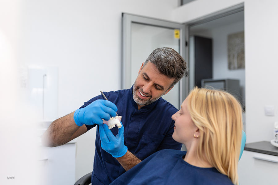 Dentist discusses the benefits of dental crowns with his patient