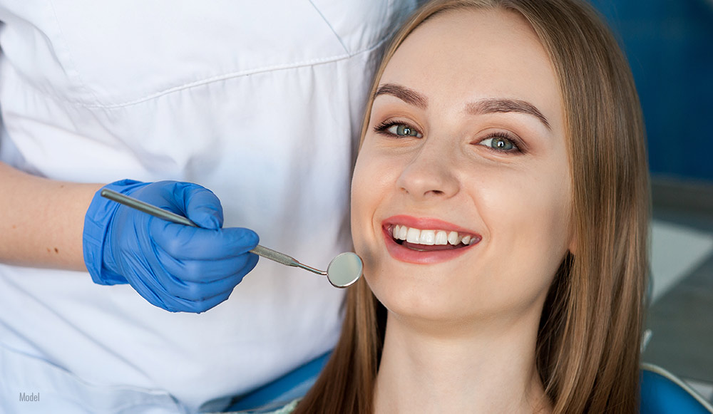 female healthy smile at dental office